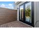 Inviting outdoor patio features a wood privacy screen and black framed glass doors to the interior at 2328 Mason Drive Dr, Atlanta, GA 30316