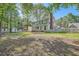 Expansive backyard with a well-maintained lawn, tall trees, and a charming white picket fence at 3664 Bonnie Glenn Ln, Tucker, GA 30084
