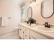 The bathroom has double sinks with black hardware and oval mirrors at 3664 Bonnie Glenn Ln, Tucker, GA 30084