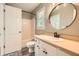 Well-lit bathroom featuring a vanity, an oval mirror, and a shower-tub combination at 3664 Bonnie Glenn Ln, Tucker, GA 30084