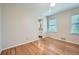 Bedroom with two windows, and hardwood floors that lead to a connected bathroom at 3664 Bonnie Glenn Ln, Tucker, GA 30084