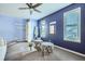 Bonus room with blue walls, lots of light, and a clear acrylic coffee table at 3664 Bonnie Glenn Ln, Tucker, GA 30084