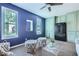 Finished room with blue walls, two windows and built in cabinets and a mini fridge at 3664 Bonnie Glenn Ln, Tucker, GA 30084