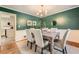 Elegant dining room with bold green walls and a modern chandelier at 3664 Bonnie Glenn Ln, Tucker, GA 30084