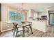 The dining room has lots of natural light, and has a modern table and chairs at 3664 Bonnie Glenn Ln, Tucker, GA 30084