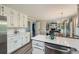 Spacious kitchen with white cabinetry and stainless steel appliances, open to the dining and living areas at 3664 Bonnie Glenn Ln, Tucker, GA 30084