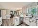 Modern kitchen featuring white cabinets, stainless steel appliances, and an island with a sink at 3664 Bonnie Glenn Ln, Tucker, GA 30084