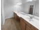 Bright bathroom featuring double sinks, ample counter space, and modern fixtures at 409 Kenley Ct, Mcdonough, GA 30253