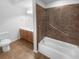 Clean bathroom featuring tile floors, a shower and tub, and a vanity with light wood cabinets at 409 Kenley Ct, Mcdonough, GA 30253