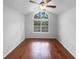 Vaulted bedroom with hardwood floors, a ceiling fan, and a large window showcasing the outdoors at 409 Kenley Ct, Mcdonough, GA 30253