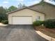 Exterior of the garage on a sunny day with driveway and partial garden views at 409 Kenley Ct, Mcdonough, GA 30253