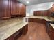 Kitchen featuring stainless steel appliances, granite countertops, and dark wood cabinets at 409 Kenley Ct, Mcdonough, GA 30253