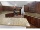 Spacious kitchen featuring dark wood cabinetry, granite countertops, and stainless steel appliances at 409 Kenley Ct, Mcdonough, GA 30253