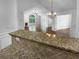 Open concept living room with granite countertops and stainless steel appliances visible at 409 Kenley Ct, Mcdonough, GA 30253