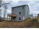 View of the back of the property with a wooden deck and blue siding at 6615 Bluffview Dr, Douglasville, GA 30134