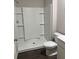 Modern bathroom featuring a walk-in shower with a white tiled surround and vinyl flooring at 6615 Bluffview Dr, Douglasville, GA 30134