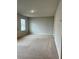 Bright bedroom featuring carpet flooring, neutral walls, and a window for natural light at 6615 Bluffview Dr, Douglasville, GA 30134