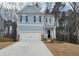 Charming two-story home with a two car garage, light blue siding and black shutters at 6615 Bluffview Dr, Douglasville, GA 30134