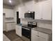 Well-appointed kitchen with white cabinetry and stainless steel appliances at 6615 Bluffview Dr, Douglasville, GA 30134