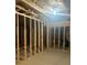 Unfinished basement featuring exposed wood frame, concrete floors, and electrical wiring at 6615 Bluffview Dr, Douglasville, GA 30134