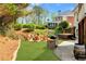 Private backyard features a brick-paved patio, outdoor kitchen, fire pit, and hot tub at 7430 Polo Hl, Cumming, GA 30040