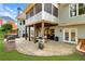 The sprawling backyard features a brick patio with grill, dining table, and an inviting fire pit area at 7430 Polo Hl, Cumming, GA 30040