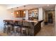 Basement bar area featuring a copper countertop, brick flooring, and custom shelving at 7430 Polo Hl, Cumming, GA 30040