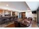 Stylish bar area with comfortable seating, rustic wood accents, and a well-stocked bar at 7430 Polo Hl, Cumming, GA 30040
