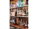 Close-up of a fully stocked bar with a variety of liquor and a built-in tap system at 7430 Polo Hl, Cumming, GA 30040