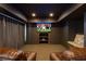 Finished basement boasts a cozy media room, perfect for movie nights and entertaining guests at 7430 Polo Hl, Cumming, GA 30040