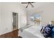 Cozy bedroom with wood floors, a ceiling fan, and natural light from the windows at 7430 Polo Hl, Cumming, GA 30040