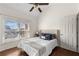 Comfortable bedroom offers natural light, hardwood floors, and ceiling fan at 7430 Polo Hl, Cumming, GA 30040