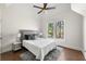 Bedroom with hardwood floors, large windows, neutral colors, and a stylish rug at 7430 Polo Hl, Cumming, GA 30040