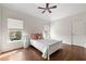 Bedroom featuring hardwood floors and natural light from the large window at 7430 Polo Hl, Cumming, GA 30040