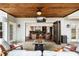 Comfortable covered patio includes a stone fireplace, TV, ceiling fan and an outdoor entertaining area at 7430 Polo Hl, Cumming, GA 30040