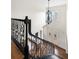 View of the entryway from the stairs featuring a decorative chandelier and glass-paneled doors at 7430 Polo Hl, Cumming, GA 30040