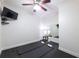Bright exercise room with rubber floor, yoga mats, ceiling fan, and a full-length mirror at 7430 Polo Hl, Cumming, GA 30040
