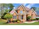 Beautiful brick home with a well-maintained lawn, showcasing classic architecture and inviting landscaping at 7430 Polo Hl, Cumming, GA 30040