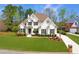 Charming two-story home with a well-manicured lawn and lovely landscaping at 7430 Polo Hl, Cumming, GA 30040