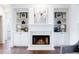 Elegant fireplace with white mantel, built-in shelving, and a cozy ambiance at 7430 Polo Hl, Cumming, GA 30040