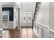 Elegant foyer with hardwood floors, decorative double doors, and a staircase at 7430 Polo Hl, Cumming, GA 30040