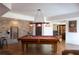 Well lit game room with a pool table, brick wall, and custom dartboard for entertainment and recreation at 7430 Polo Hl, Cumming, GA 30040
