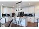 Bright kitchen featuring stainless steel appliances, white cabinets, granite countertops, and modern pendant lighting at 7430 Polo Hl, Cumming, GA 30040