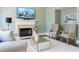 Comfortable living room with a fireplace, neutral-toned furniture, and stylish decor at 7430 Polo Hl, Cumming, GA 30040