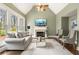 Bright living room with fireplace and vaulted ceiling featuring neutral-toned furniture at 7430 Polo Hl, Cumming, GA 30040