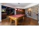 Spacious recreation room featuring a pool table, exposed brick wall, and custom lighting at 7430 Polo Hl, Cumming, GA 30040