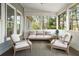Cozy screened porch with comfortable seating, ideal for relaxing and enjoying the outdoors at 7430 Polo Hl, Cumming, GA 30040