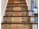Unique staircase with wooden steps lined with corks and decorated with wine crate labels at 7430 Polo Hl, Cumming, GA 30040