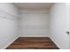 Empty walk-in closet featuring hardwood floors and white shelving at 7430 Polo Hl, Cumming, GA 30040