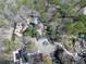 This aerial view shows a home's roof, driveway, and surrounding trees in the community at 120 Huntcliff Pt, Atlanta, GA 30350
